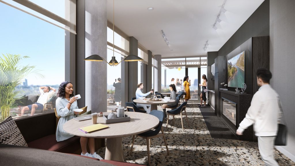 People sitting in a bright apartment lounge with tables, a fireplace, TV, and large windows.