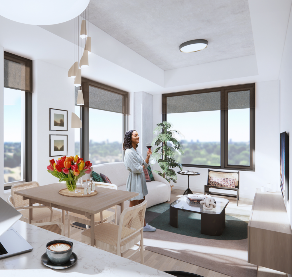 Woman holding a glass of wine in a bright apartment living room with tulips and large windows.