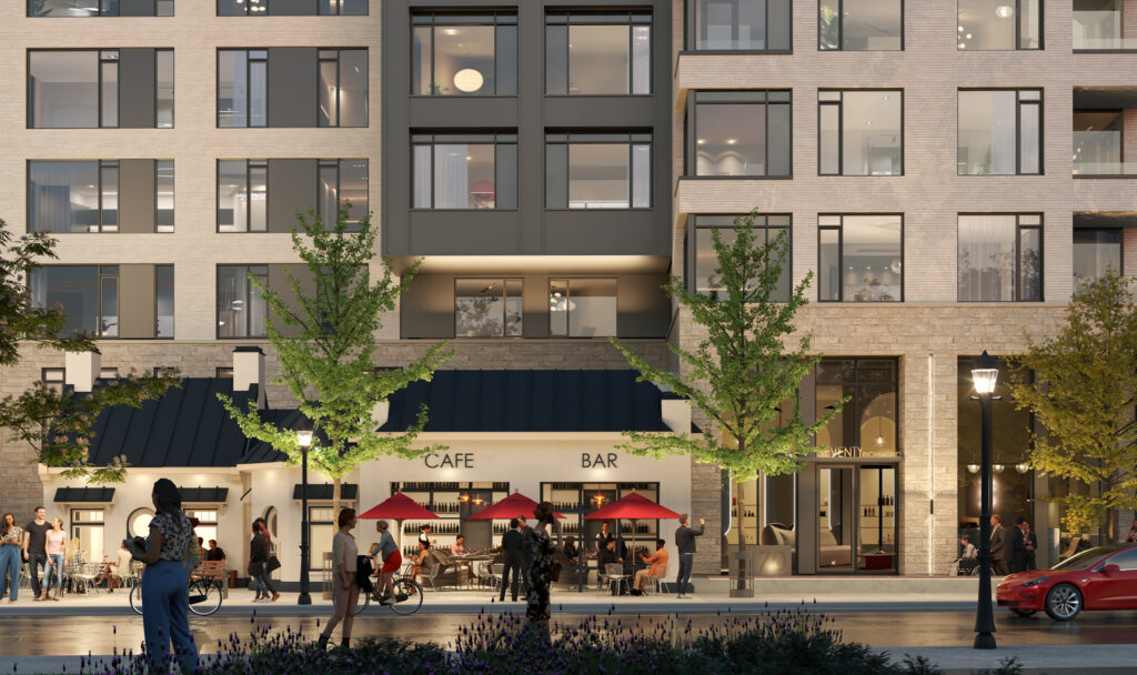 People sitting and walking outside a black and white apartment building with red umbrellas.