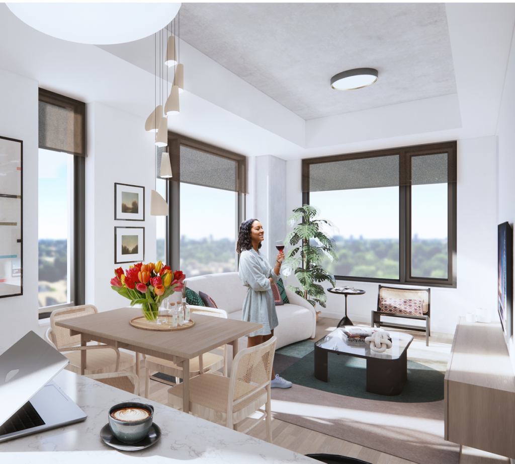 Woman holding a glass of wine in a bright apartment living room with tulips and large windows.