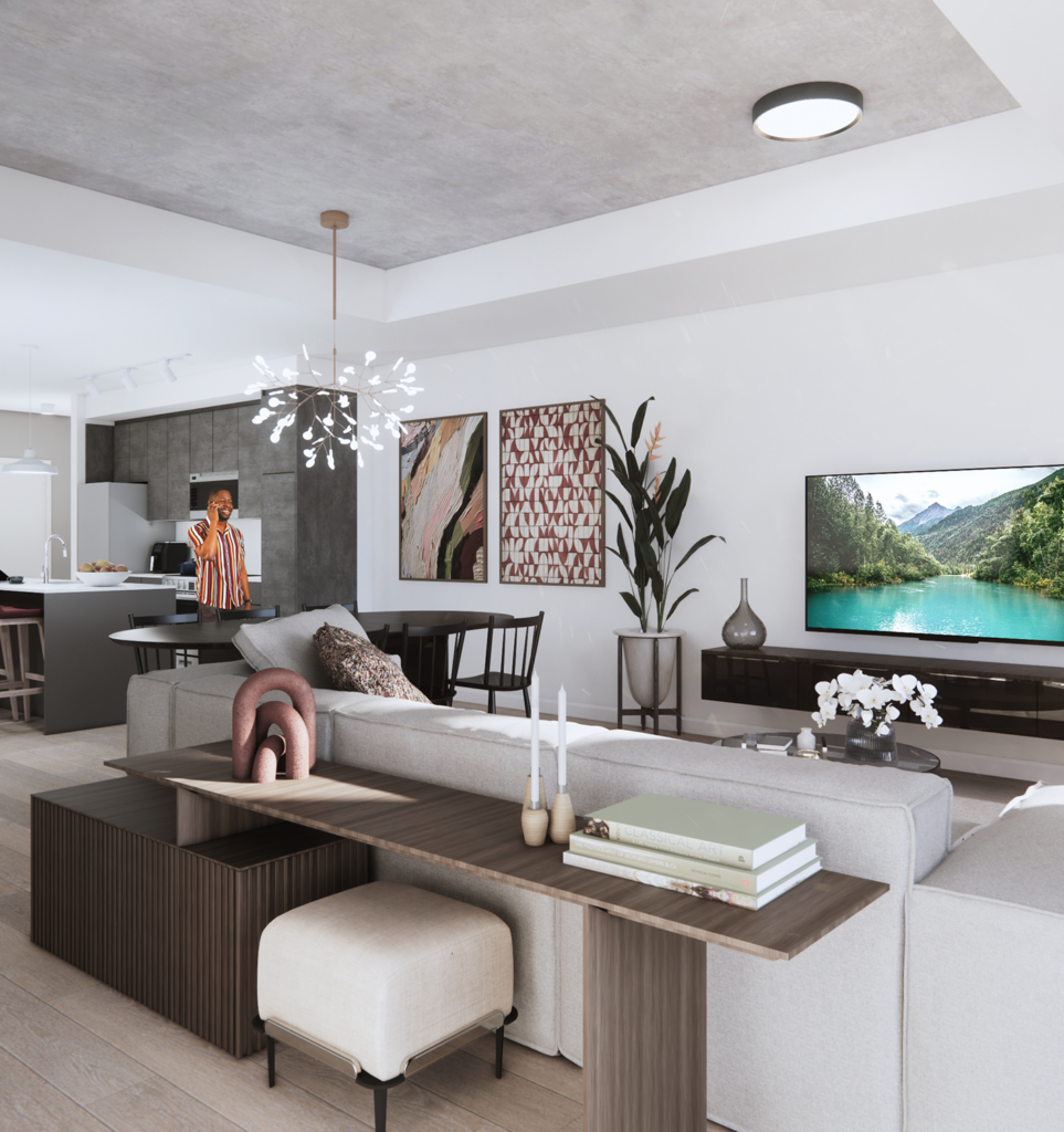 Person standing in an apartment kitchen beside a living room with a couch, TV, and wall art.