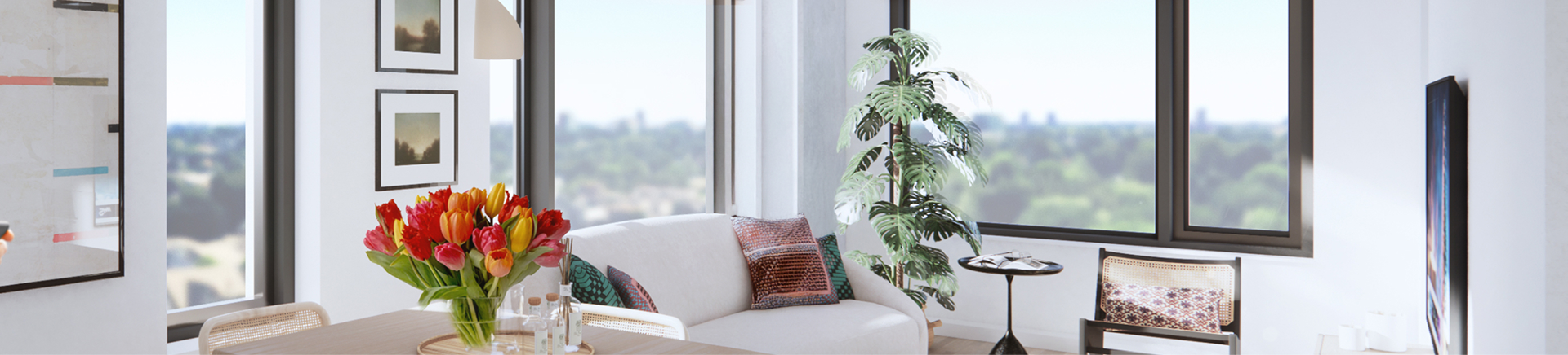 Bright apartment living room with tulips, a couch, plant, and windows.